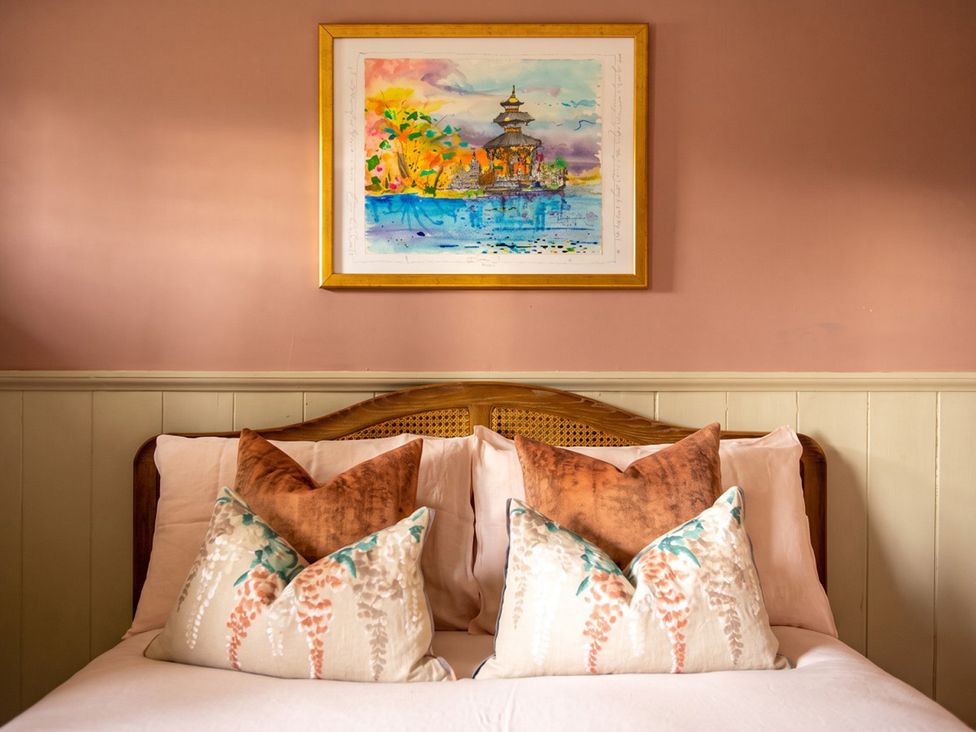 A bedroom with a bed and decorative pillows at 