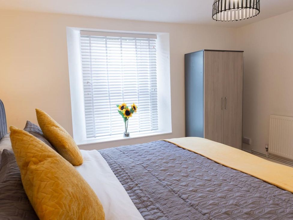 A bedroom with a bed and window at The Old Barn in Manchester