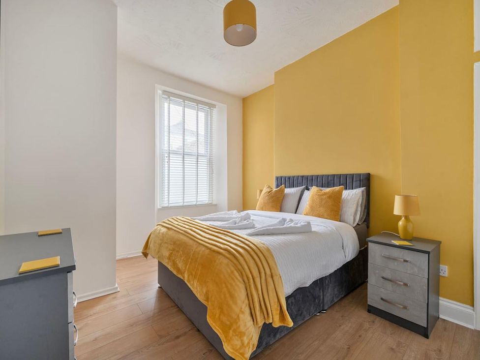 A bedroom with a bed and bedside table at The Old Barn in Manchester