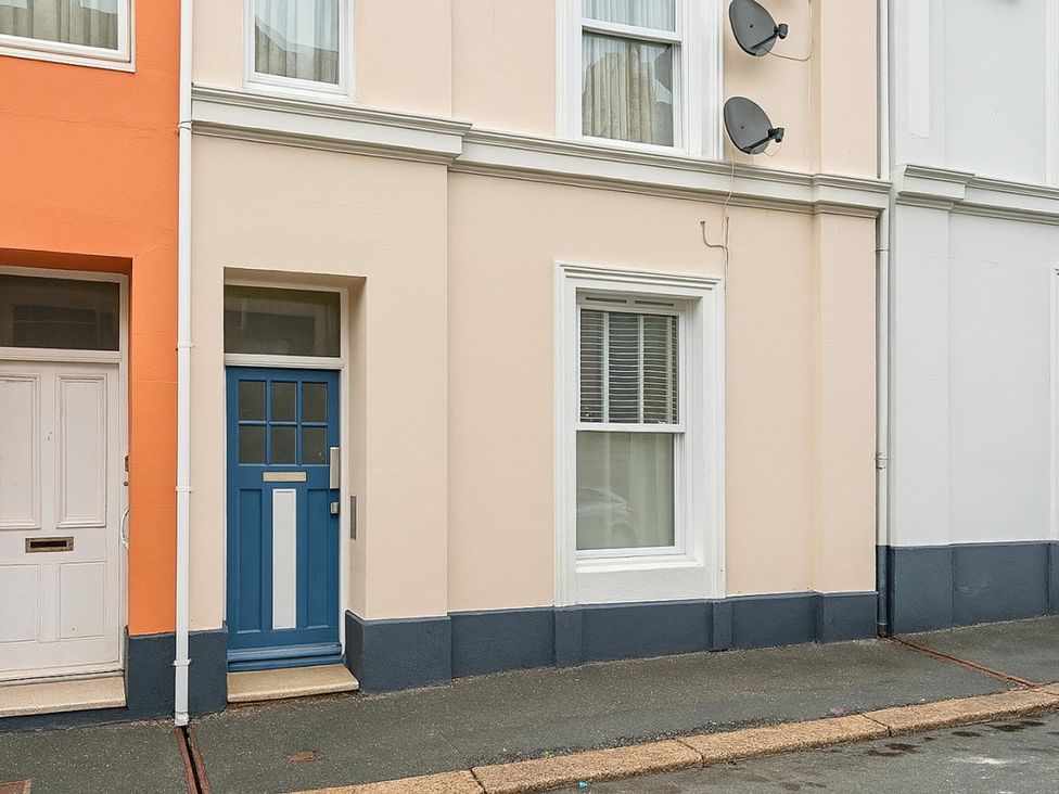 A building entrance with a blue door and a window in the exterior at an unspecified location
