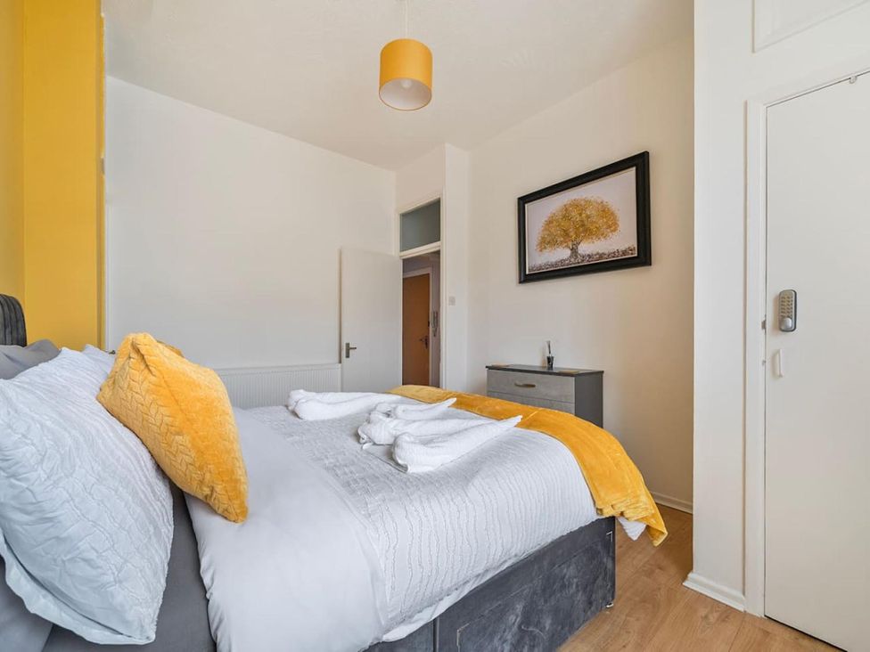 A bedroom with a bed and a chest of drawers at The Old Barn in Manchester