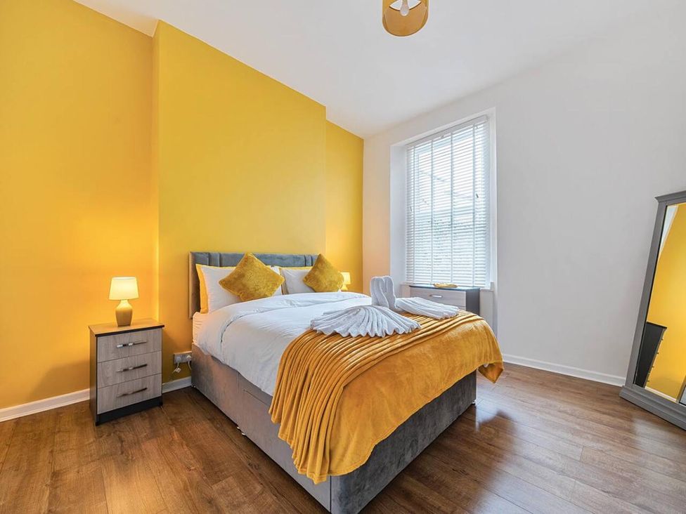 A bedroom with a bed and nightstand at a property in an unspecified location