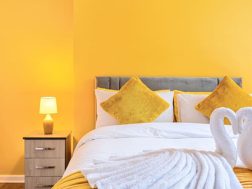A bedroom with a bed and bedside table at The Old Barn in Manchester