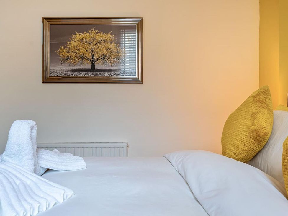A bedroom with a bed and a picture frame at the property in location
