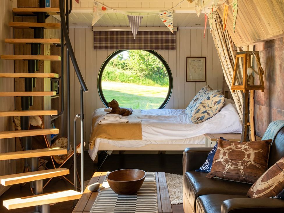 A bedroom with a bed and a spiral staircase at 
