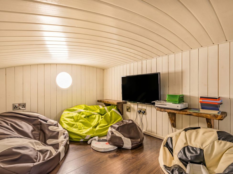 A snug with bean bags and a television at the property