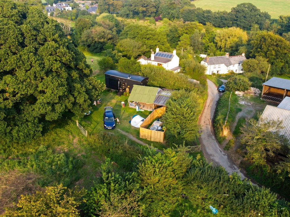 An outdoor view with houses and vehicles at a rural location
