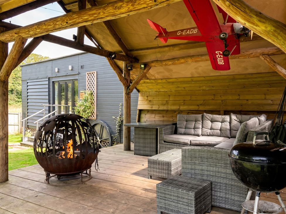 An outdoor patio with seating and a fire pit at the property