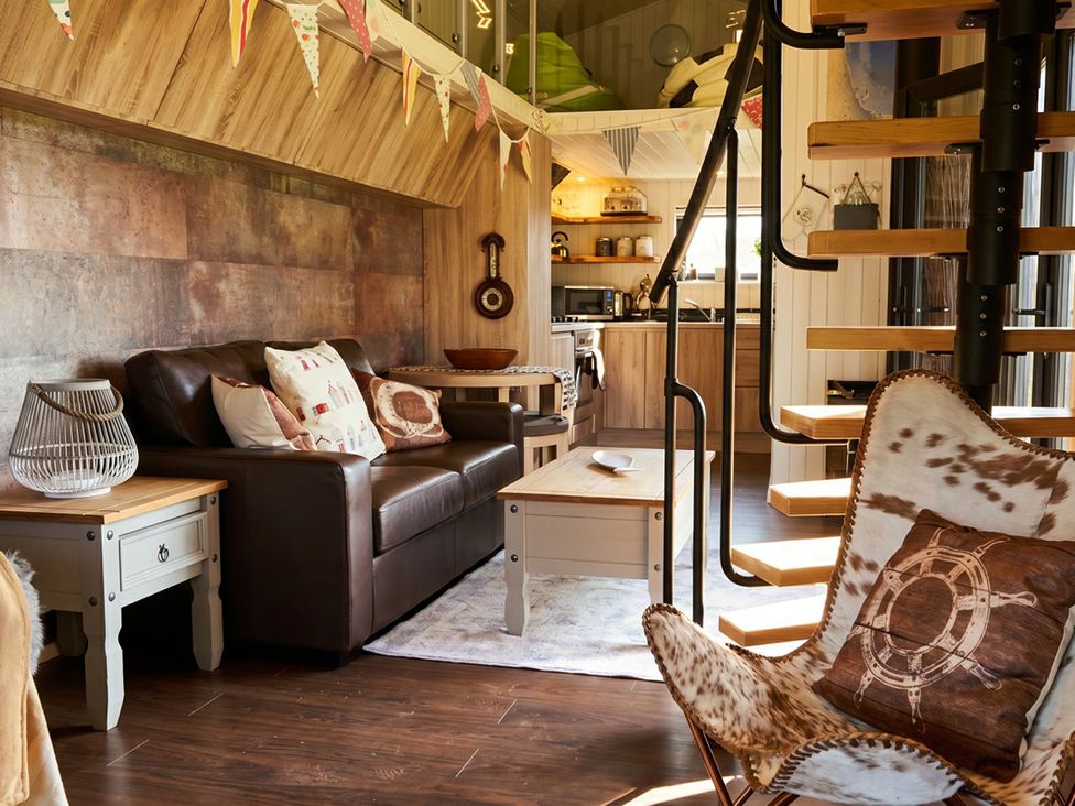 A living room with a sofa and coffee table at The Old Barn in Manchester