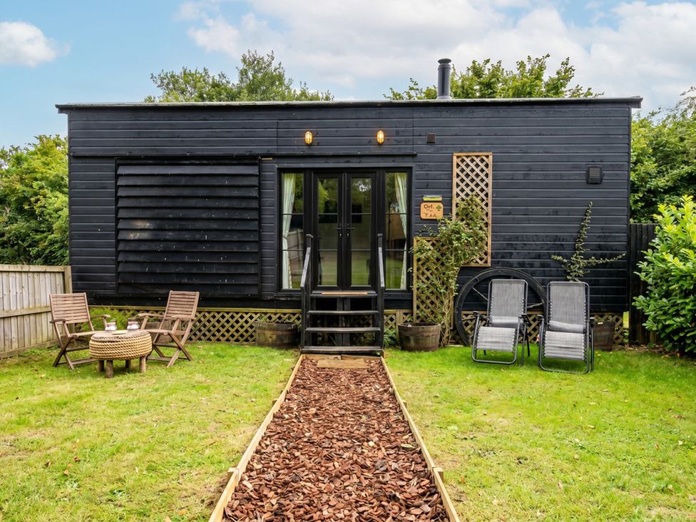 An outdoor area with seating and a pathway at a property