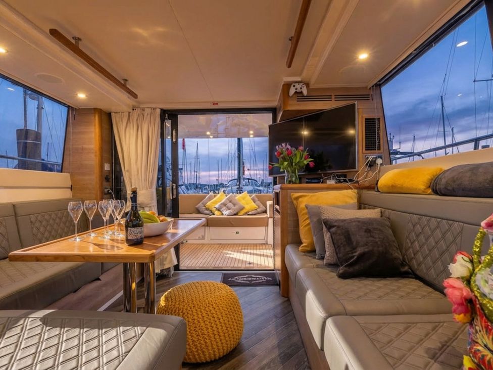 A living room with a table and seating area on a boat