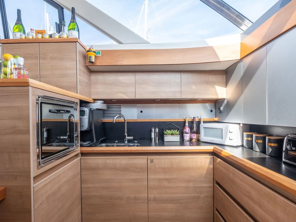 A kitchen with a sink and microwave at a property in unspecified location