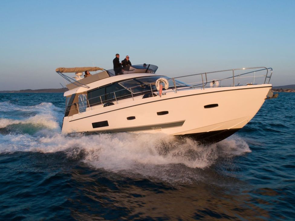 A boat navigating through water with people on board