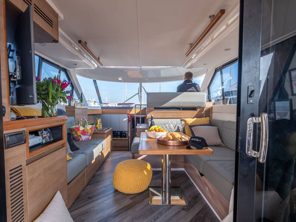 A living room with a table and seating area on a boat