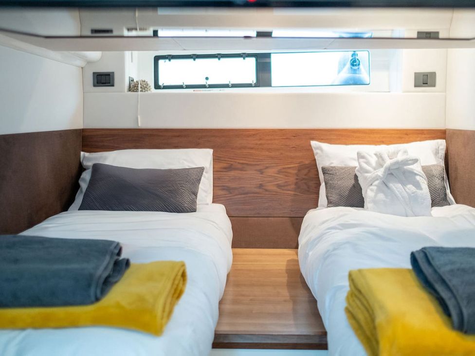 A bedroom with two beds and a window