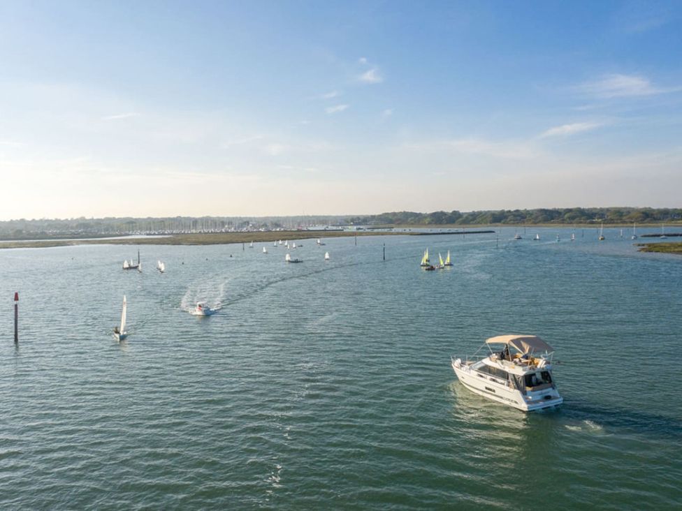 A water scene with boats and sailing activity at an unspecified location