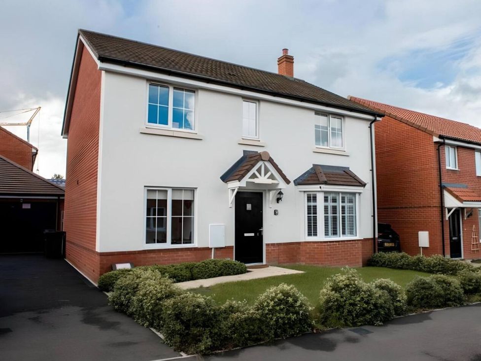 A house with a garden and driveway at a residential area