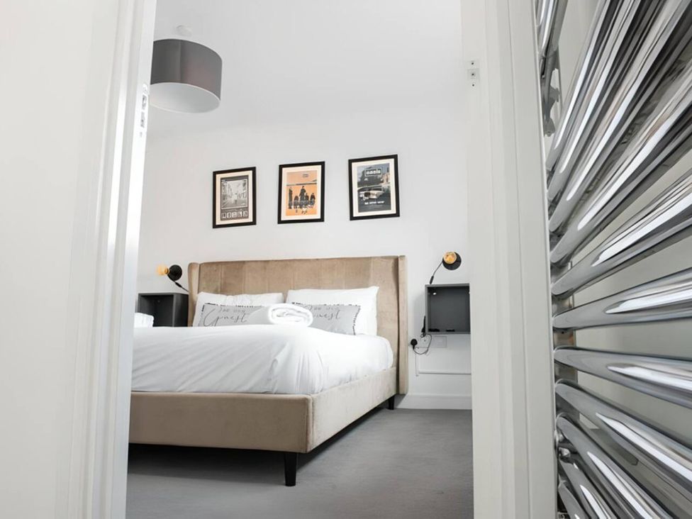 A bedroom with a bed and wall art at unspecified location