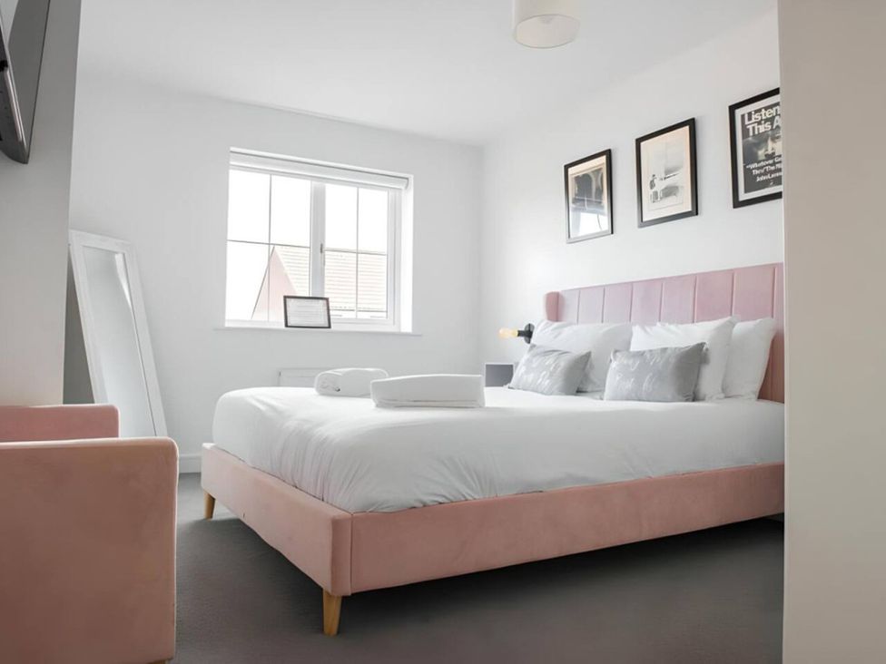 A bedroom with a bed and a chair at The Old Barn in Manchester