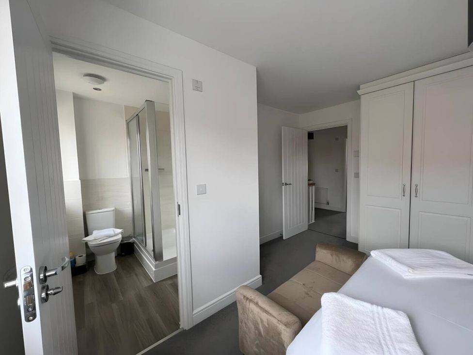 A bedroom with bed and bathroom access at 