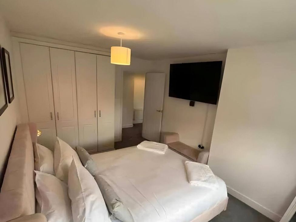 A bedroom with a bed and wardrobe at 