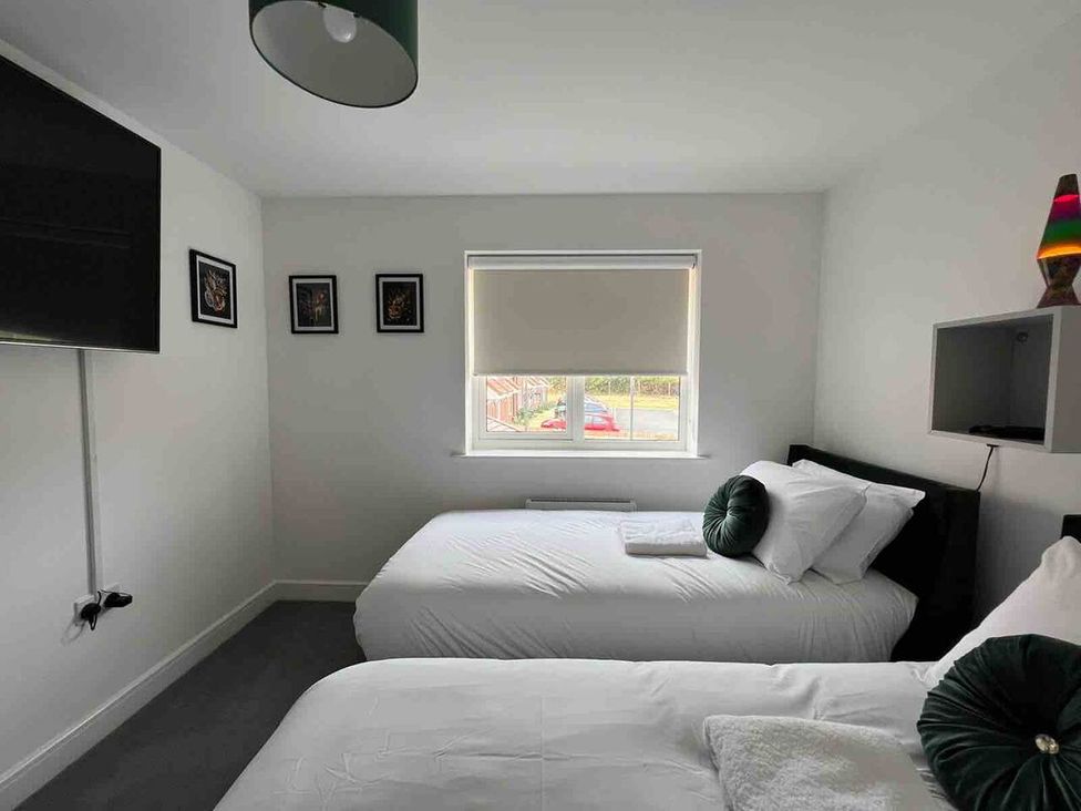 A bedroom with two beds and a television at the property