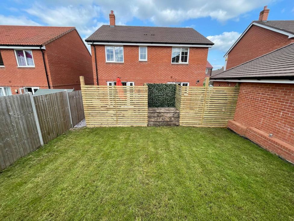A garden with a lawn and wooden fence at an unspecified location