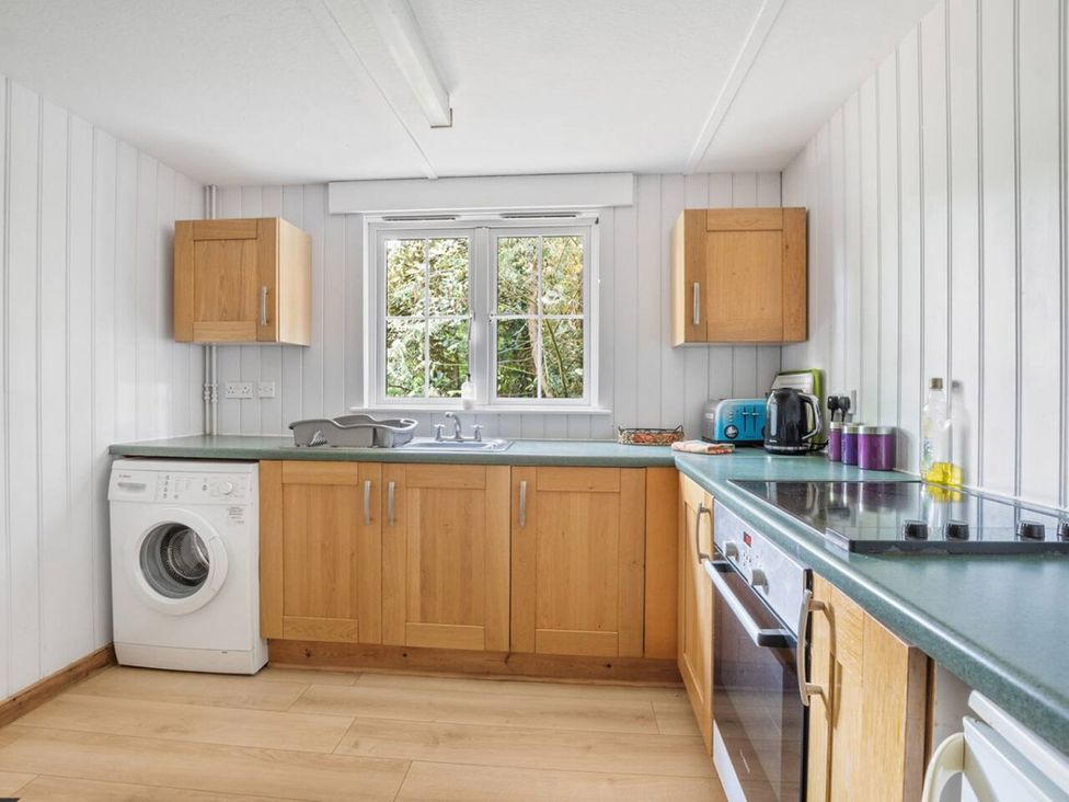 A kitchen with a washing machine and sink at The Hideaway
