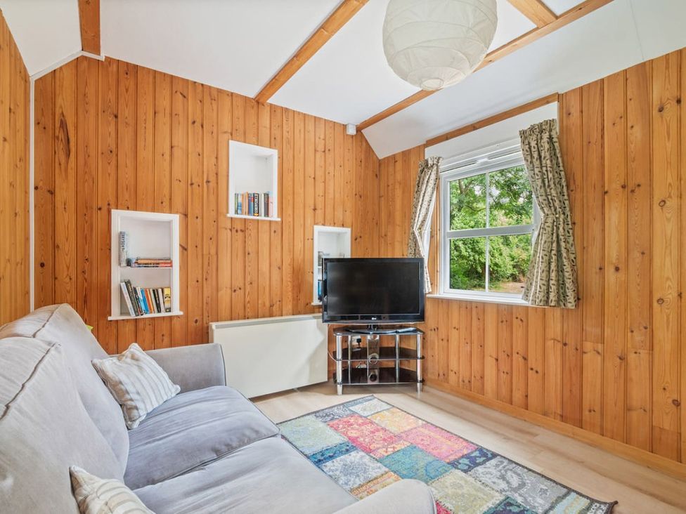 A snug with a sofa and television at The Hideaway