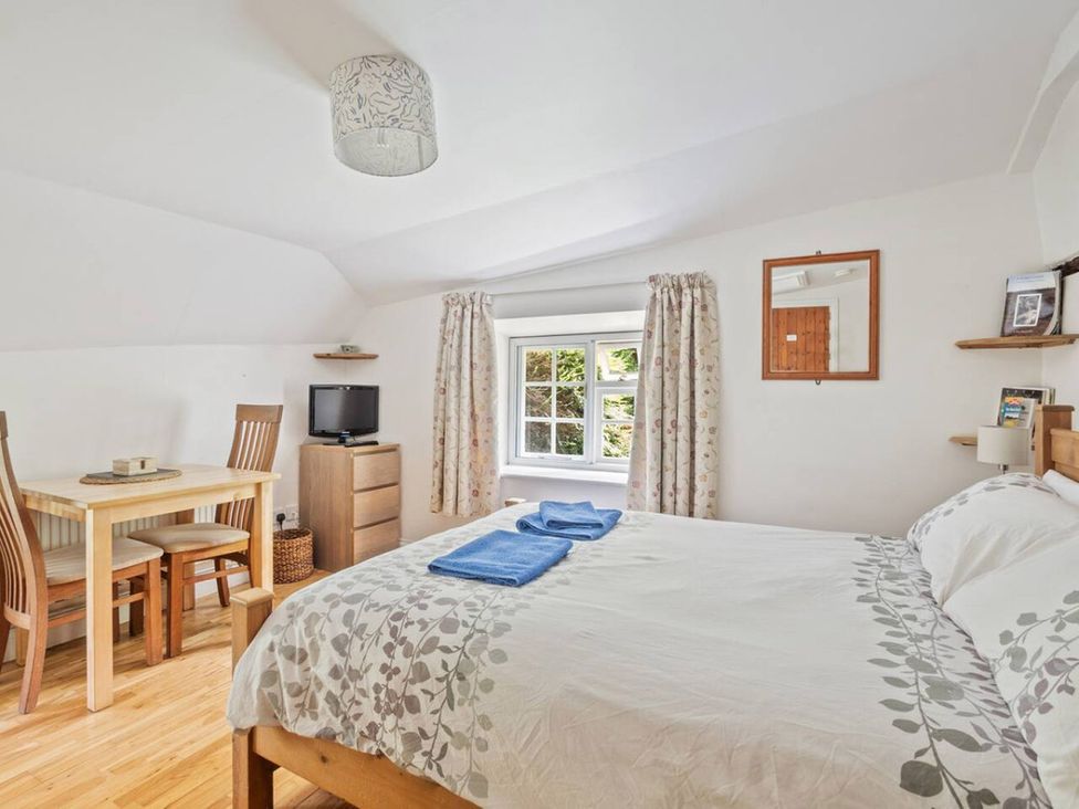 A bedroom with a bed and dining table at Old Post Office