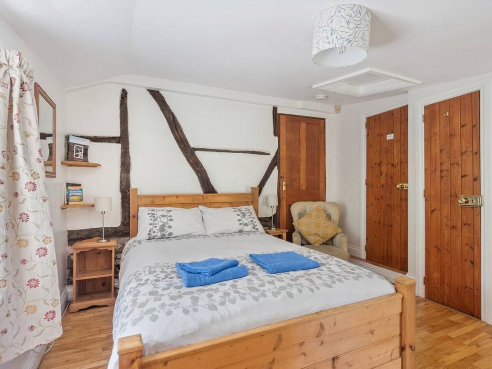 A bedroom with a bed and wooden furniture at The Old Post Office in 