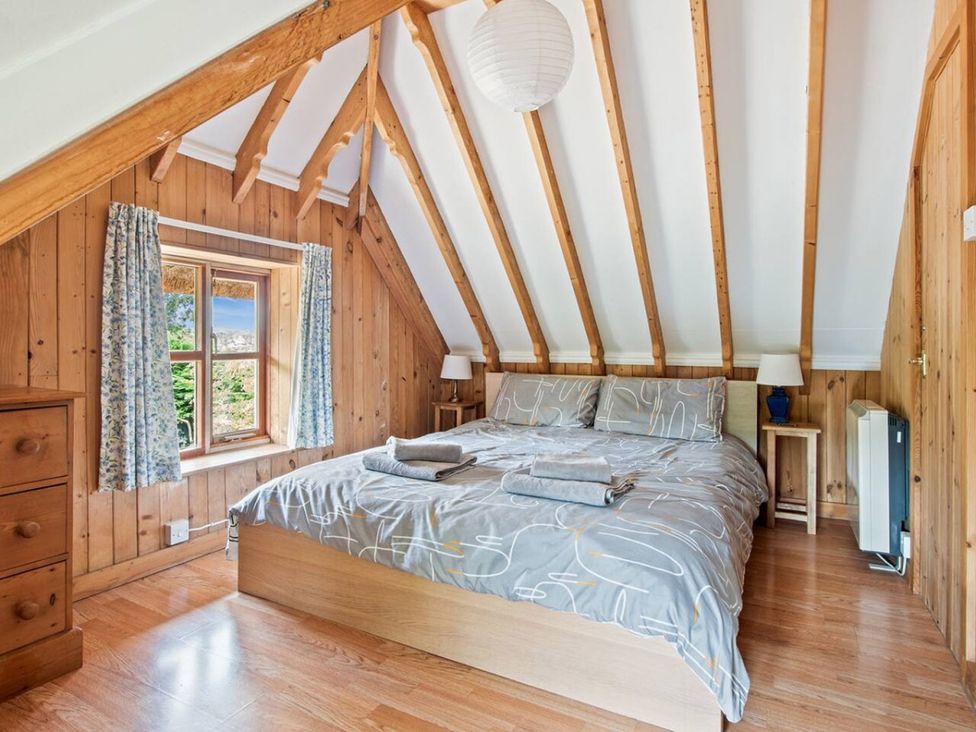 A bedroom with a bed and window at Walnut Tree Cottage in 