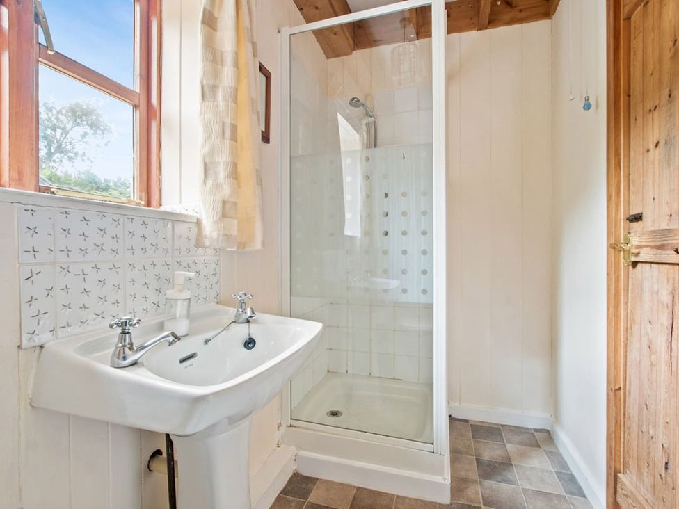 A bathroom with a shower and sink at Walnut Tree Cottage 