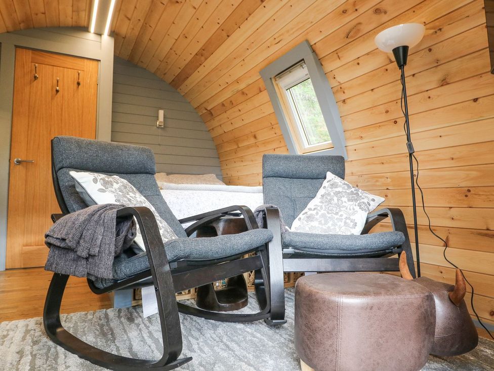 A snug with rocking chairs and a bed at Elleric Pods - The Last Resort, Appin