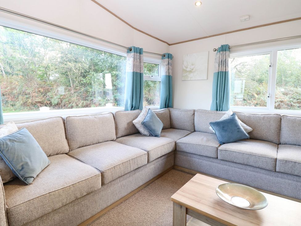 A living room with a sofa and coffee table at Four Seasons in Great Yarmouth