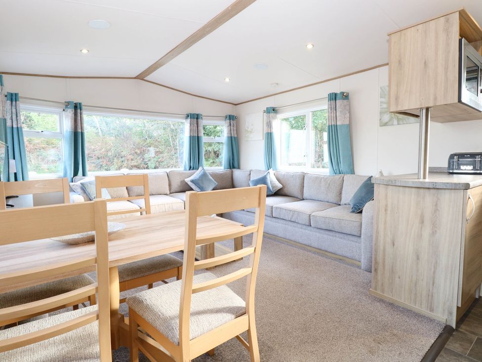 A living room with a sofa and dining table at Four Seasons in Great Yarmouth