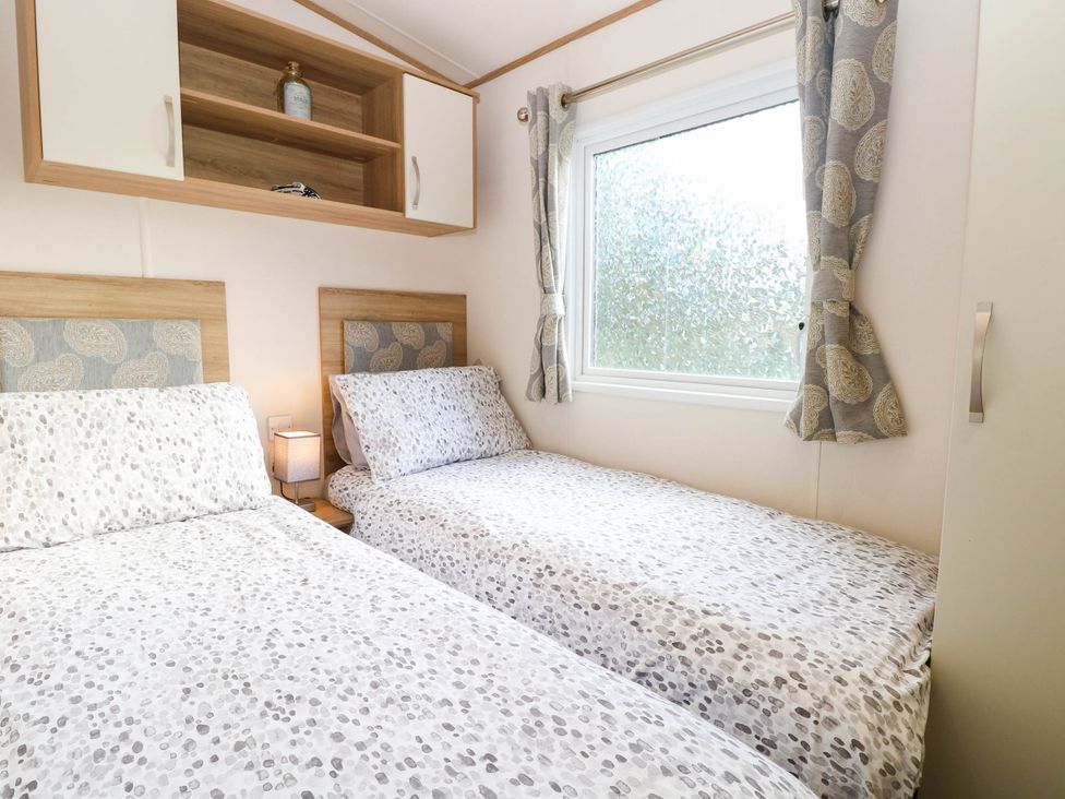 A bedroom with two single beds at Four Seasons in Great Yarmouth