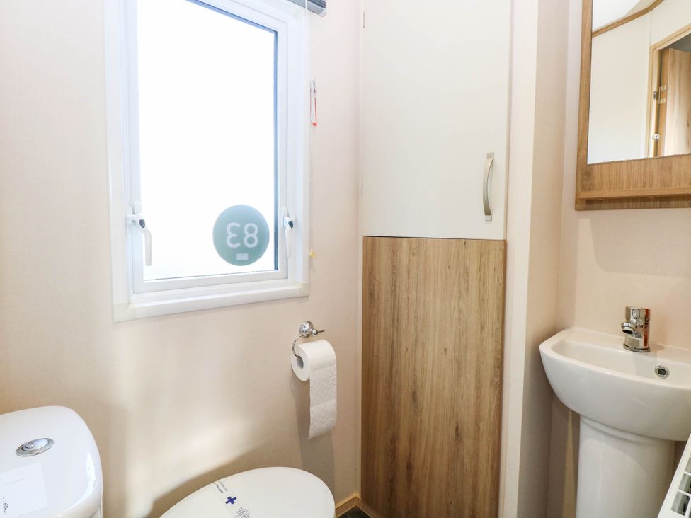 A bathroom with a toilet and sink at Four Seasons in Great Yarmouth