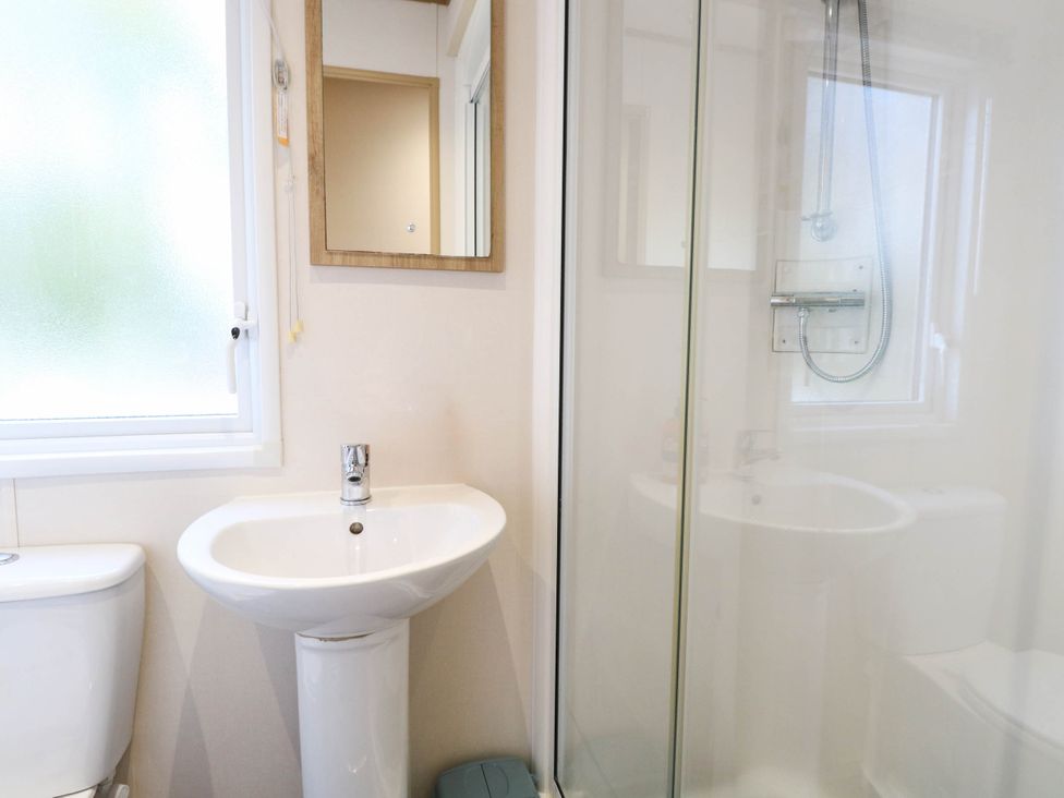 A bathroom with a sink and mirror at Four Seasons in Great Yarmouth