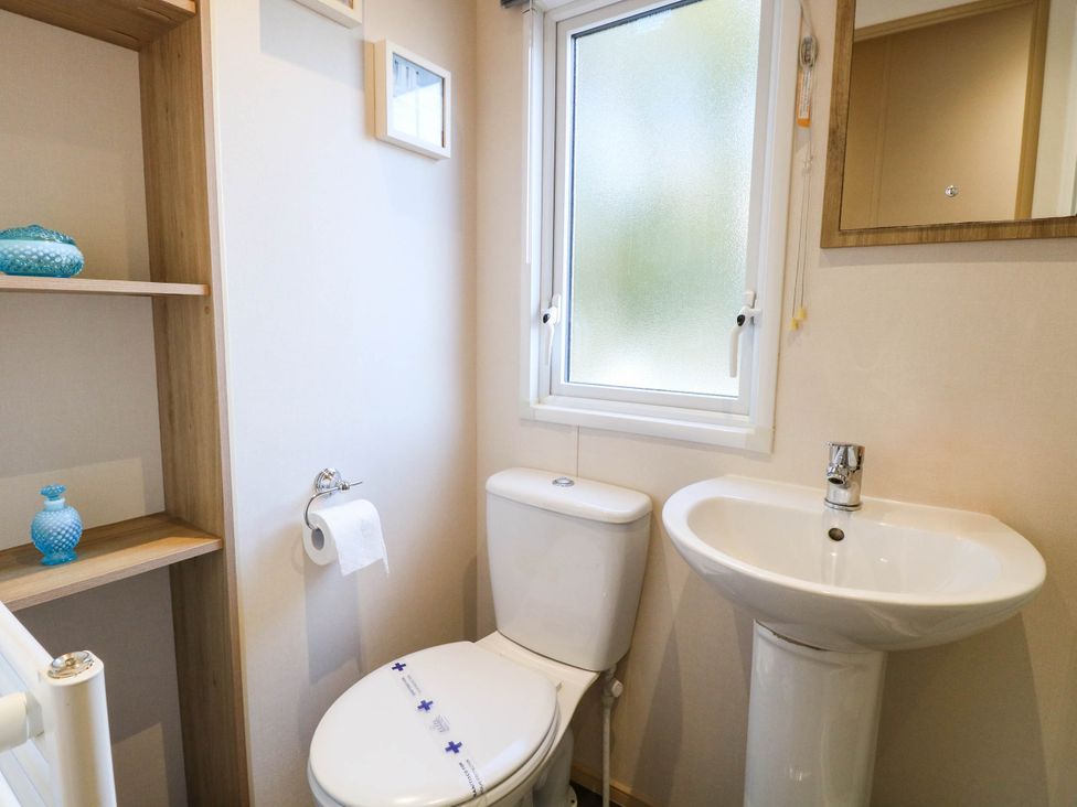 A bathroom with a toilet and sink at Four Seasons Great Yarmouth