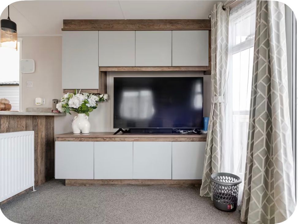A living room with a television and storage unit at Brookwood Willerby, 36 bay view Filey