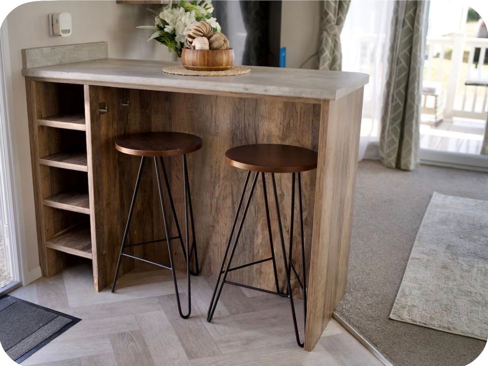 A kitchen bar with two stools and shelves at Brookwood Willerby, 36 bay view, Filey