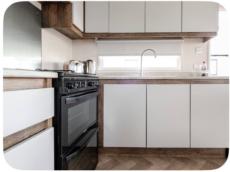 A kitchen with an oven, sink, and kettle at Brookwood Willerby, 36 bay view, Filey