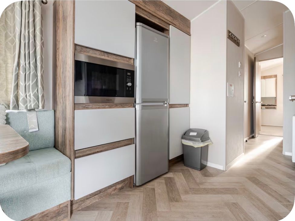 A kitchen with refrigerator and microwave at Brookwood Willerby, 36 bay view, Filey