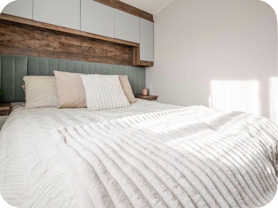 A bedroom with a bed and pillows at Brookwood Willerby, 36 bay view, Filey