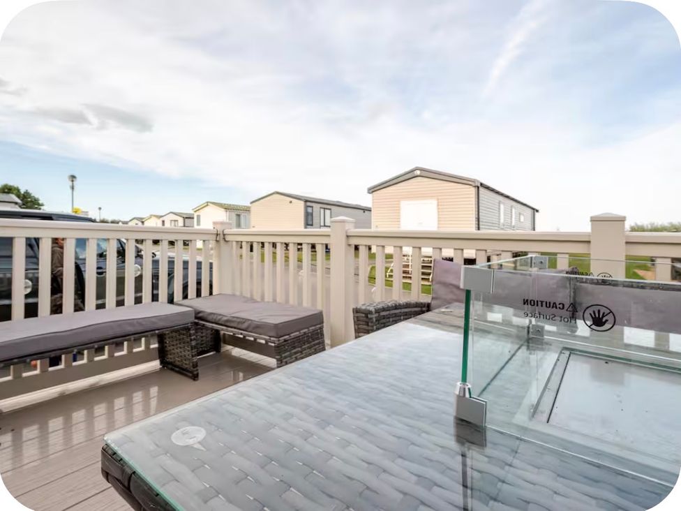 An outdoor seating area with a table and couch at Brookwood Willerby, 36 bay view Filey