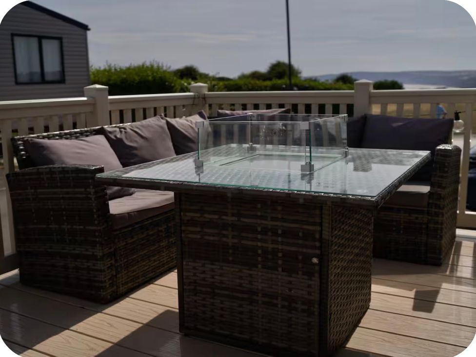 An outdoor seating area with a table and couch at Brookwood Willerby, 36 bay view, Filey