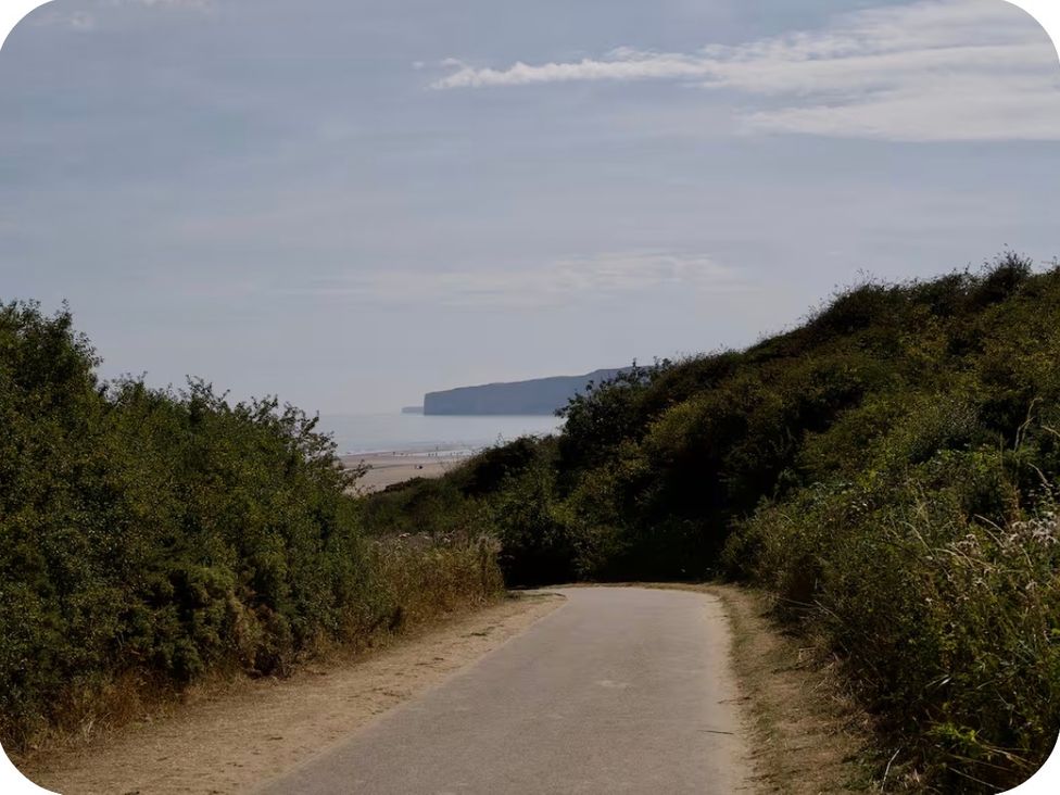 A path leading to the beach with cliffs in the distance at Brookwood Willerby, 36 bay view, Filey