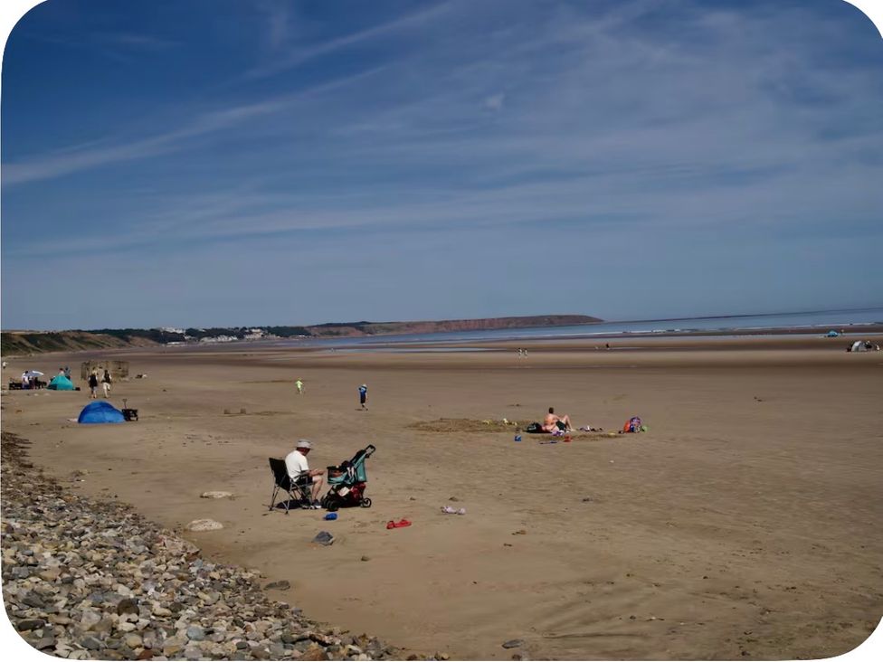 A beach with people and tents at Brookwood Willerby, 36 bay view, Filey
