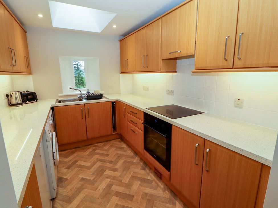 A kitchen with cabinets and appliances at Swallow's Nest in Keswick